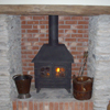 New fire place beam and slate hearth with traditional stove